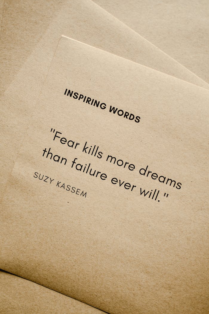 About Motivational quote 'Fear kills more dreams than failure ever will.' by Suzy Kassem on paper texture.
